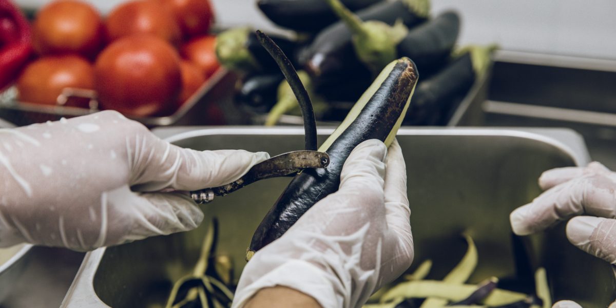 Peeling the black skin of eggplants. High quality photo