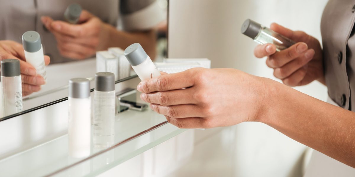 Close up of a young hotel maid putting bath accessories in a bathroom