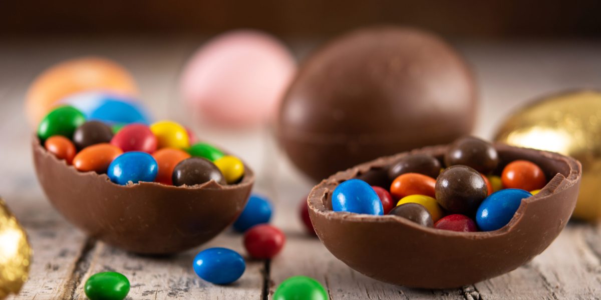 Colorful chocolate Easter eggs on wooden table
