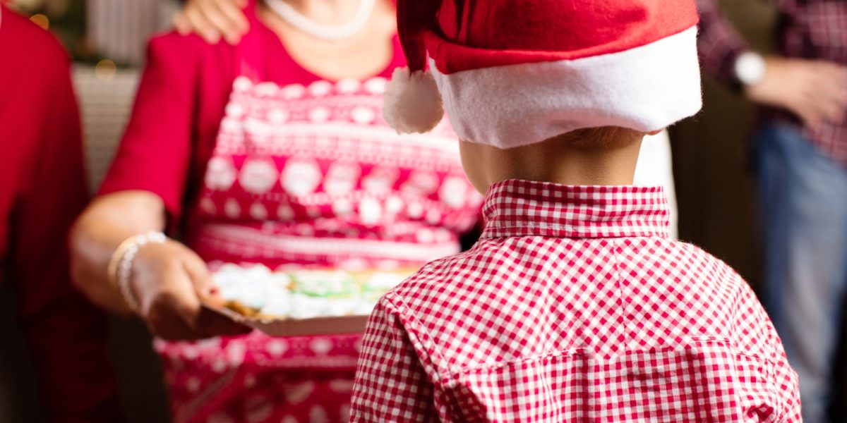 Christmas scene. grandmother offering bisquits her grandson